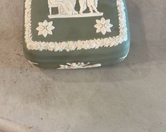 Wedgwood Jasperware Trinket Box — Classic Wedgwood jasperware rectangular trinket box in muted green with white relief neoclassical figures and floral border. Marked on the underside "E M WEDGWOOD MADE IN ENGLAND," indicating English manufacture; the box displays crisp applied white bas-relief and intact rim details. Good estate condition with only light surface wear and no visible chips or cracks in photos. Compact decorative storage piece for jewelry or small keepsakes; measures roughly 4 x 3 x 1.5 inches.