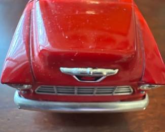Red Vintage 1955 Chevy — Red diecast-style toy pickup truck with classic 1950s lines and painted chrome trim. Sturdy metal construction with plastic windows and simple wheel axles; bed has ribbed silver floor detail. Compact collectible-size model ideal for display on a shelf or in an office room; estimated dimensions and weight listed below. Good used condition with light surface scuffs and tiny paint chips consistent with gentle play or handling.