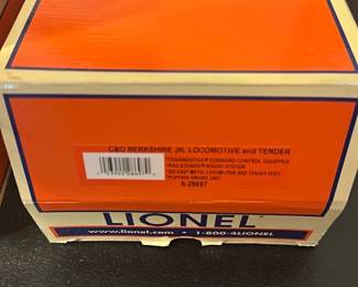 Lionel C&O Berkshire Jr Locomotive — Lionel Chesapeake & Ohio (C&O) Berkshire Jr. locomotive and tender in original orange box, shown in protective styrofoam with locomotive and matching tender. The set includes detailed driving rods and painted lettering on the tender; appears complete in packaging with light shelf wear to box. Mechanical condition untested — sold as a collectible model train piece; ideal for collectors or hobbyists familiar with Lionel O- or O27-gauge models.