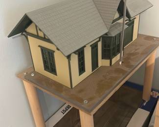 Bachmann Gold Canyon Valley Depot — Bachmann Gold Canyon Valley Depot HO-scale model building shown here on a simple display stand. The plastic and painted detail captures a small depot with bay window, chimney and platform; includes an attached semaphore signal. Good cosmetic condition with minor shelf wear to the box visible; appears complete but sold as-is without track or additional scenery. Compact model suitable for HO model railroad layouts or display.