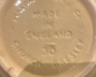 Made in England Chamberlain 36 — Glazed ceramic bowl marked "MADE IN ENGLAND" with an impressed "CHAMBERLAIN" name and the number "36" on the base. The bowl has a warm tan exterior glaze with molded geometric panels and a glossy white interior; it appears to be sturdy, heavier pottery suitable for display or kitchen use. Surface shows crazing consistent with age and light rim wear but no obvious large chips or cracks visible in photos. Approximately medium-large in size and useful as a serving or decorative piece.