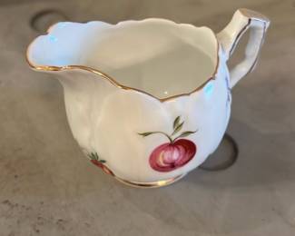 Aynsley "Florida" Creamer — Aynsley "Florida" bone china creamer in the classic English floral pattern with hand-painted peach/red fruit motifs and gilt trim. Marked on the base with the Aynsley crown backstamp, "EST. 1775" and "England Fine English Bone China"; pattern name "Florida" is printed as shown. Light surface wear and a few small glaze frits at the rim consistent with normal use but no obvious chips or large cracks visible in photos. Compact and elegant, suitable for tea service or display with other fine china; measures approximately as noted below.
