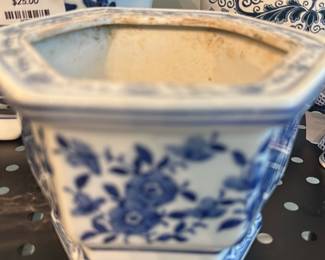 blue white floral cachepot — Blue-and-white floral ceramic cachepot with traditional scrolling border and hand-painted style floral panels. Sturdy squared form tapers to a narrower foot and shows age-appropriate crazing and surface staining inside; exterior glaze has light wear at rim. Good decorative planter for mantel or dining-room display; measures modestly and is easy to repurpose as a small indoor planter or decorative container.
