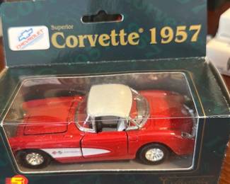 Corvette 1957 Diecast Model — This collectible 1957 Corvette diecast model comes in original retail display box and captures the classic red and white two-tone styling. The model features detailed chrome trim, realistic wheels, and a removable-looking hardtop (fixed in model); packaging reads "Corvette 1957" and displays Chevrolet branding. Compact and perfect for shelf or desk display; boxed size is small and easy to store or gift. In good condition overall — box shows light shelf wear and the model appears intact with no visible chips or missing parts.