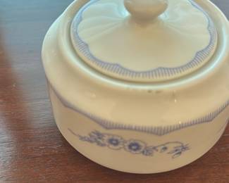 Mayer China Co. Covered Sugar Bowl — Mayer China Co. covered sugar bowl with blue floral band and scalloped lid edge, marked on the base "Mayer China Co. Beaver Falls PA" and pattern number 183. Hard-paste porcelain piece with a classic blue-and-white transfer floral motif; small size suitable for a dining table or tea service. Appears in good condition with normal light surface wear and no visible chips or cracks in the photos. Lid fits snugly and markings are clear on the base.
