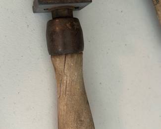 Glass Cutter / Wheel Hand Tool — A vintage hand glass cutter with a turned wooden handle and metal cutting head. The tool shows honest age with patina and surface rust on the metal parts and wear to the wooden grip; the cutting wheel assembly appears intact though condition may affect performance. Compact handheld tool useful for hobby glass cutting or as a display piece for tool collectors. Handle measures roughly palm-size and the metal head is secured with screws as shown.
