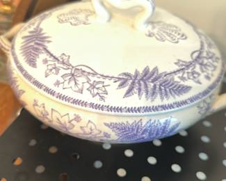 Covered Serving Tureen 13 Mark — Hard-paste ceramic covered serving tureen with two loop handles and a matching lid decorated with purple transfer-printed ferns and ivy motifs. Interior shows age-related staining and crazing; exterior glaze has the expected crazing and light surface wear consistent with use. Base is marked with the number "13" (see photo) which may be a workshop or pattern mark; no maker name visible. Good usable condition for display or serving with vintage character.