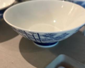 Blue & White Porcelain Bowl Japan — Blue-and-white porcelain bowl stamped "JAPAN" on the base, decorated with traditional cobalt floral/landscape motifs around the exterior. Lightweight tableware piece likely mid-20th century export porcelain; the clear base stamp suggests Japanese manufacture. Surface appears clean with no obvious chips or cracks visible in photos, minor glazing wear consistent with gentle use. Measures small-to-medium size suitable for rice, soup, or display.