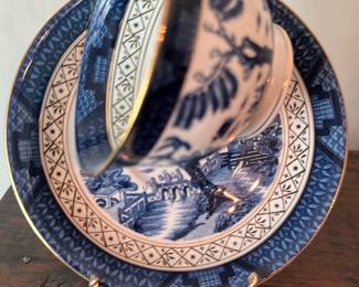 Blue White Cup & Saucer — Blue and white ironstone teacup and saucer set featuring transferware pastoral/bridge scenes and decorative geometric borders. Marked on base "IRONSTONE WARE MADE IN OCCUPIED JAPAN" (green backstamp) indicating post-WWII production; gilded rim trim present. Cup and saucer show visible crazing and light rim wear consistent with age; no obvious chips but some surface wear to gilt. Good estate-sale condition for display or casual use; attractive on a teacup rack or for a collector of Occupied Japan ironstone.