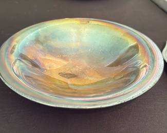 Silver Plated Bowl — Silver plated shallow bowl with an iridescent, rainbow-toned surface and a beaded edge detail. The piece displays light surface wear and minor spotting consistent with age and plating wear but retains attractive luster and color shift in reflected light. Good decorative accent for a dresser, vanity, or table—solidly made and showing expected patina for silver plate. Measures small and shallow making it easy to display or use for small items.