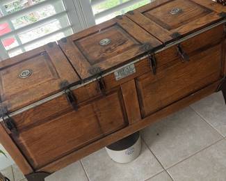 IDEAL Toledo Cooker's Oak Icebox — This IDEA L / The Toledo Cook er Co. oak three-compartment icebox is a striking early-20th-century kitchen piece with original galvanized liners and hinged lids. Constructed of solid oak with metal hardware and cast-iron style legs, it features three round galvanized tubs for ice and a maker's plate reading "IDEAL The Toledo Cooker Co. Toledo, Ohio" (patented 1914). Measuring approximately to fit as a decorative storage/console, it works well in a sun room or entry and offers authentic period character. Overall good condition for display with expected surface wear, patina to metal liners, and minor scuffs to wood consistent with age; hardware appears intact but liners show oxidation.