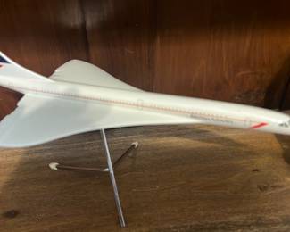 Space Models Concorde Desk Model — Scale desk model of the Concorde produced by Space Models (label shows "space models London, England"). White resin/plastic construction on a metal tripod display stand with British Airways-style tail livery and printed fuselage markings. Good collectible condition with light surface scuffs and small paint wear consistent with display; stand intact. A mid-size decorative aviation model ideal for a desk or shelf display.