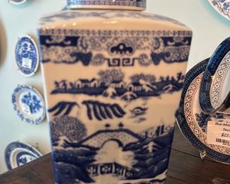 Ringtons Blue & White Ginger Jar — Decorative blue and white ceramic ginger jar marked RINGTONS Limited, Tea Merchants, Newcastle upon Tyne. Square-shouldered lidded urn with traditional willow/landscape transfer pattern in cobalt blue on white glaze; sturdy ceramic construction ideal for living room display. Approximately 10 inches tall and 5 inches wide (see dimensions) and moderately heavy for easy display on a table or shelf. Good vintage condition with light surface crazing and minor rim wear consistent with age; maker's mark on base is clear. A charming collectible piece from a British tea merchant brand suitable for collectors or decorative use.