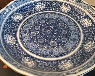 Blue & White Chinese Porcelain — Blue & White Chinese Porcelain decorative charger/serving dish with dense hand-painted cobalt floral and scrolling motifs across the well and border. The underside bears a small painted mark (shown) that suggests an East Asian maker; overall the glaze is glossy with no obvious large chips visible in photos. A substantial display piece for tabletop or wall mounting — shows light surface wear consistent with age and use. Measures as noted below.