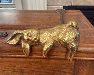 Brass Bunny Shelf Figurine — Solid brass bunny figurine with a warm golden patina and textured surface detail; felted base protects furniture. A decorative paperweight or mantel accent that shows light surface wear consistent with normal use but no cracks or repairs. Compact and heavy for its size, it works well as a desk weight or shelf ornament and pairs nicely with traditional wood furnishings.