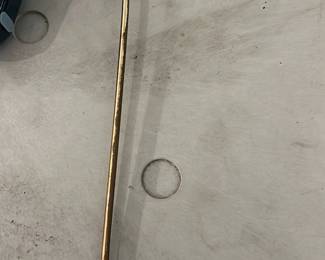 Brass Flower Candle Snuffer — Brass candle snuffer shaped like a long stem with a curled handle and a flower-shaped bell at the end. Solid brass construction with a gentle patina and light surface wear consistent with age and use; the flower bell shows small dark spots from use. Lightweight, decorative and functional for extinguishing candles; measures as shown below. No maker's marks visible.