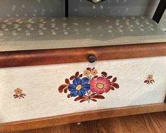 Wood & Ceramic Floral Bread Box — Wood-and-ceramic bread box with hand-painted floral motif on the front panel and a hinged wooden frame. Interior is glazed ceramic and shows light staining consistent with age and use; exterior wood has minor surface wear and patina. Practical countertop piece for kitchen storage or decorative use; measures compactly and is easy to move. No maker marks visible in photos.