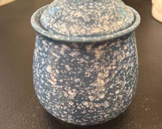 Blue Spongeware Ceramic Lidded Jar — Small blue speckle glazed ceramic jar with a fitted lid, shown empty and in hand for scale. The interior is glazed deep blue and the base is unmarked with a visible ring of unglazed foot; overall surface shows normal glaze variation but no chips or cracks visible in photos. Useful as a sugar jar, salt cellar, or small decorative storage piece; compact and sturdy with a classic speckled farmhouse look.