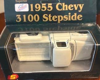 1955 Chevy 3100 Stepside Model — Collectible 1955 Chevy 3100 Stepside diecast model in original display box. The boxed model is cream/ivory colored with detailed cab and bed molding and sits in a clear plastic display window; packaging reads "1955 Chevy 3100 Stepside" and shows Superior branding. Compact boxed collectible ideal for desk display or model truck collectors; approximate box measures provided below. In good condition overall with light shelf wear and minor scuffs to the plastic window but the model appears intact and complete inside the original packaging.
