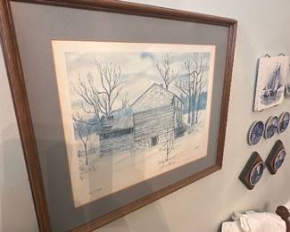 Signed Winter Barn Limited Print — Signed limited-edition landscape print titled with a winter barn scene, hand-signed by the artist (appears to read "James R..." on lower right) and numbered 110/145. Framed with double matting in a wood-tone frame and glass, the print uses muted blue-gray tones and detailed pencil/ink linework showing trees and a rustic barn. Overall framed size estimated for display in a living room; print area shown within mat. The piece is in good condition with light wear to frame and no visible tears or staining to the paper or mat from the photos. A charming, collectible limited print suitable for cottage or farmhouse-style decor and estate sale display.