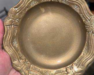 Brass Decorative Bowl with Butterflies — Heavy decorative brass bowl with molded butterfly and floral motifs around the scalloped rim and on the underside. Solid metal construction shows an aged patina and light surface wear consistent with use; no obvious dents but has surface scratches and small areas where finish is rubbed. Good heavy decorative piece for mantel, entry table, or as a catchall; measures approximately as listed and will add warm metal tone to a traditional or eclectic display.