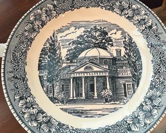 Decorative Plate — Decorative blue transferware plate featuring a classical domed mansion scene at center with a floral vine border. Made of glazed ceramic with a subtle impressed 'USA' mark on the underside; likely mid-20th century American dinnerware style. Plate measures approximately 10.5 inches diameter and is suitable for display in a living room or china cabinet. In good condition with light surface crazing visible under glaze and no obvious chips or cracks.