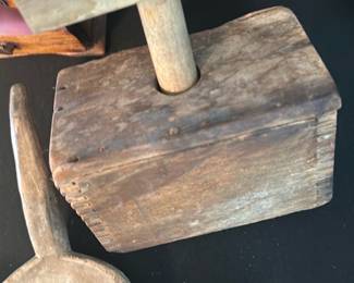 Wooden Butter Press Mold — Early folk-style wooden butter press/mold with a T-handle plunger and dovetail-joined box body. Solid carved wood shows heavy surface wear, patina, and small nail repairs consistent with age and use; the interior plunger end is darkened from repeated contact. Functional as a decorative primitive kitchen piece or display, measurements are approximate and condition is fair with visible wear, splitting at edges, and surface abrasions.