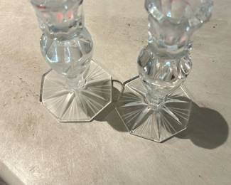 Pair Lead Crystal Candlesticks — Pair of clear lead-style crystal candlesticks with octagonal star-cut bases and faceted stems. Each shows light surface wear and small scratches consistent with age and use but no visible chips or cracks in the photos. Classic, versatile pieces that work as mantel or table décor; sold as a matching pair. Bases measure roughly 3.25 inches across and height is approximately 7.5 inches.