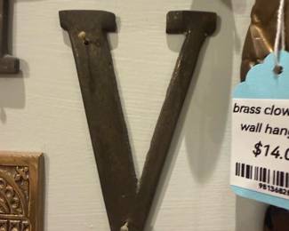 Metal Letter V Wall Hook — Heavy metal letter "V" that appears intended for wall display or as a decorative hook. Solid iron/steel construction with two pre-drilled mounting holes (top and bottom) and a dark aged patina; shows surface wear and minor rusting consistent with age. Simple typographic design works well as a single initial or grouped with other letters; measures small enough for gallery-style walls or entryways. Sold as-is with visible cosmetic wear but structurally sound for mounting.