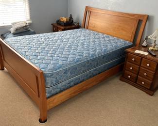 This room also has what seems to be a full-sized bed frame, a pair of nightstands, and at least one table lamp.