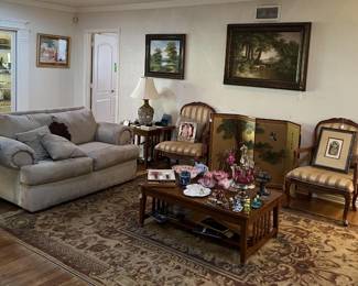 In yet another room, we have a second sofa, set of matching chairs, coffee table and framed art.  A couple of side tables and a torchiere lamp completes the picture.  Almost forgot the area rug!
