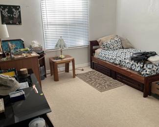 In a third bedroom there is a third bed frame, a single it seems, at least one more side table, and more.