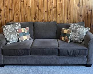 If we look from outside in, you'll see the two matching end tables, the matching table lamps, and the really comfortable deep blue sofa.