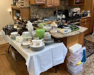 The kitchen reveals more dishes, cookware, and utensils.