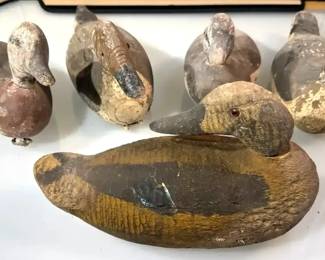 Vintage carved wooden duck decoys with painted details 