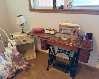 Singer sewing machine in treadle cabinet, night stand