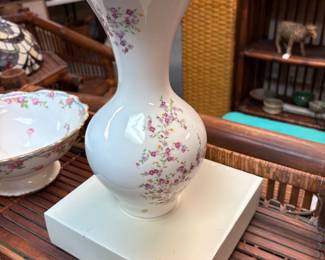 Vintage style porcelain vase with delicate floral pattern and gold rim