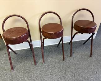 3 wood base folding stool wrapped in leather.