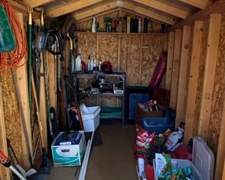 Storage Shed with Assorted Garden Tools and Supplies