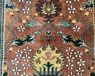 V23 - $95. Wool area rug with rust/blue colors. Measures 72.5” x 50”.