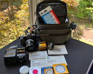V110 - $60. Minolta 700 Camera, 35-100 Lens, 50 Lens and Accessories. Untested