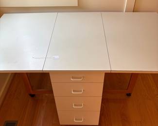 V82 - $125. Drop Leaf Sewing Craft Table. Measures 19.25” x 33” x 33.5” Tall. With both leaves it measures 61” long.