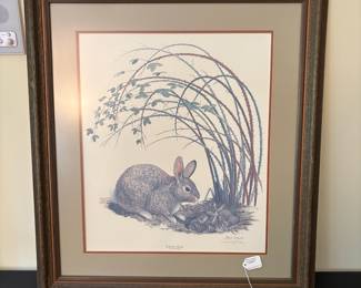 V89 - $50. “Cottontail Rabbit” by Ray Harm. Signed Print. Measures 28.75” x 32.25”.