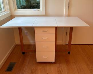 V82 - $125. Drop Leaf Sewing Craft Table. Measures 19.25” x 33” x 33.5” Tall. With both leaves it measures 61” long.