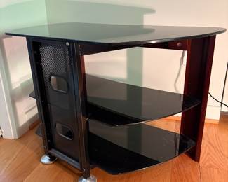V53 - $50. Glass Top Media Stand. Measures 32” x 17” x 20.25” Tall.