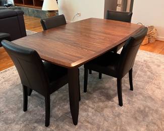 SET INFO (Priced separately V3 & V4) V3 - $2000. Amish Made Barkman Furniture - Holmes County Ohio. "Christy" Model - 66" Ext. Table. Grey Elm & Brown Maple. Measures 42” Wide x 66” Long x 30.5” Tall. Leaf measures 18”. Total table length with leaf is 84”. Excellent condition. V4 - $1600. Set of 8 Crate and Barrel Lowe Onyx Dining Chairs with Ebony Legs. Measures 18.5” Wide x 19” Deep x Floor to seat 19” x Floor to back 35” Tall. All in Excellent Condition.