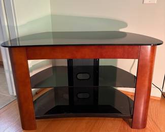 V53 - $50. Glass Top Media Stand. Measures 32” x 17” x 20.25” Tall.
