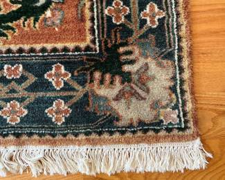 V23 - $95. Wool area rug with rust/blue colors. Measures 72.5” x 50”.