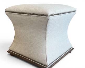 Neutral fabric covered pinched ottoman with tacking