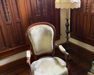 Fringe light , antique velvet chair